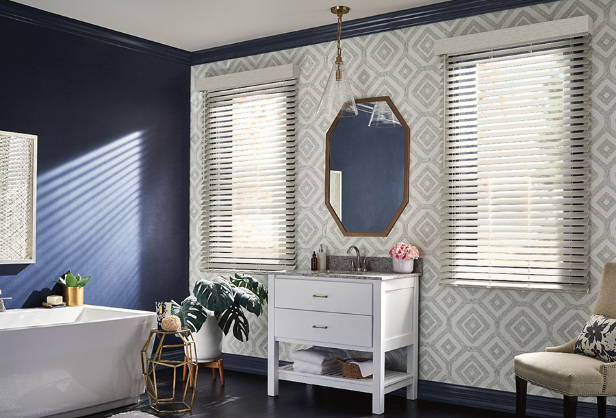 Bathroom window with faux-wood blinds for privacy and light control.