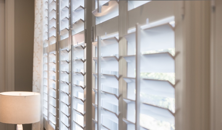 East-West windows often have glare problems during sunrises and sunsets. Plantation shutters close up