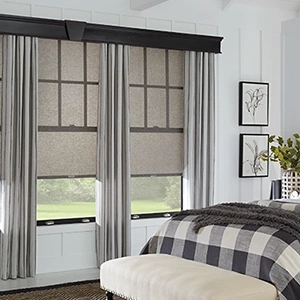 Light gray draperies with a black top cornice within a large bedroom